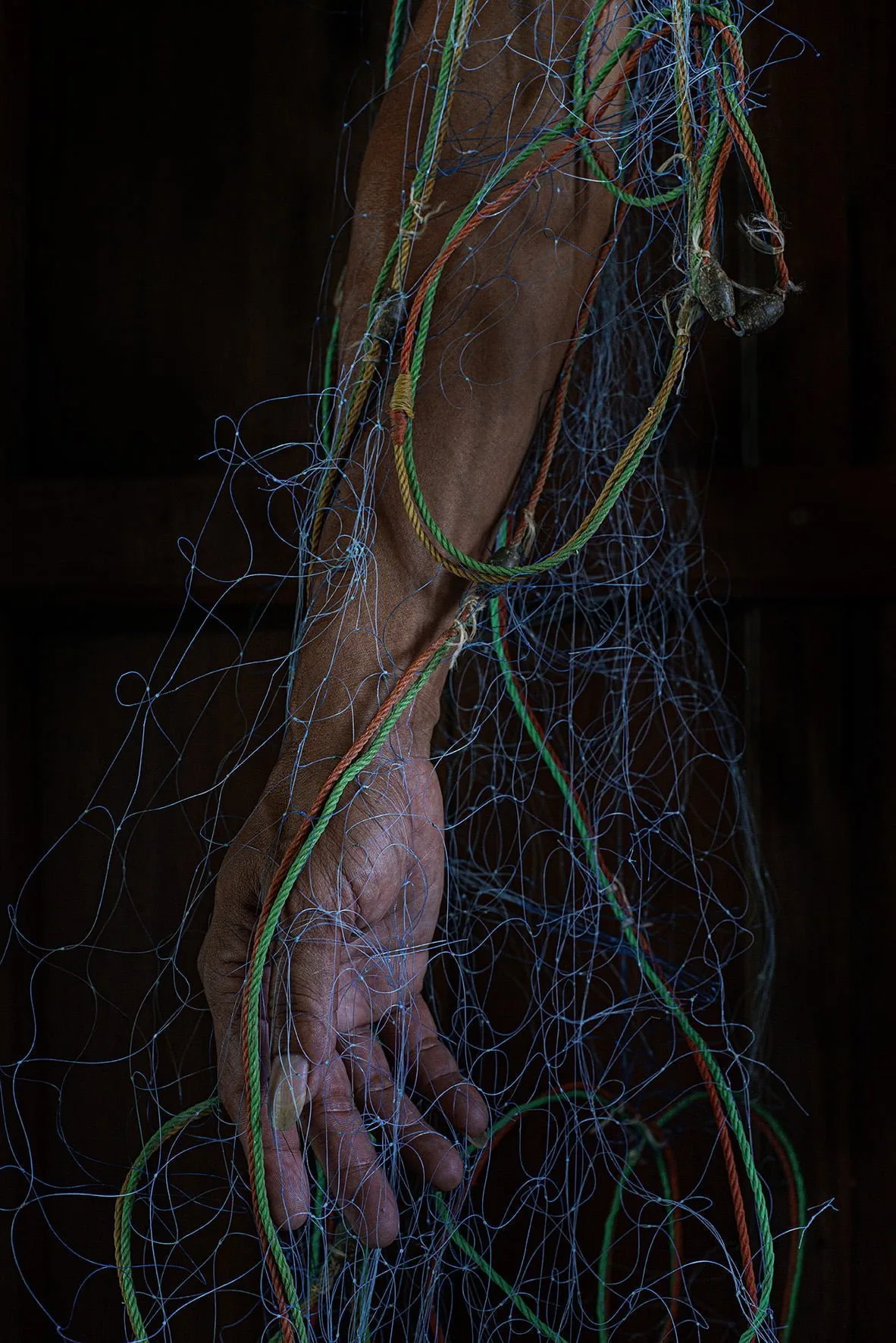 Image of a fisherman arm and his fishin net in Tom Thong Yai village.