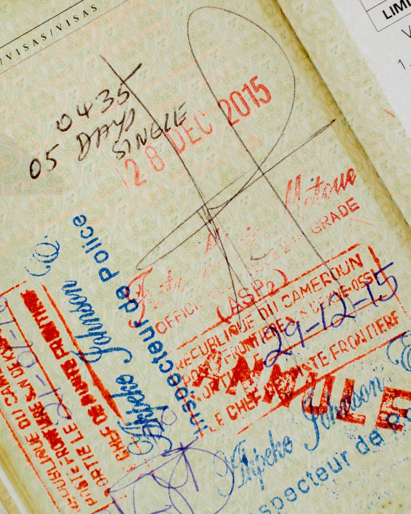 A page from Thor Pedersen's passport showing many stamps and notes from his travels.