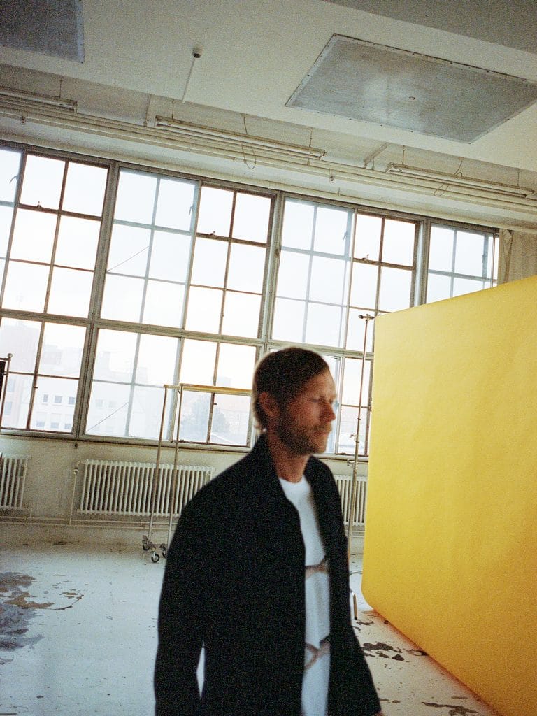 Rasmus Kofoed casually walking through a photo studio