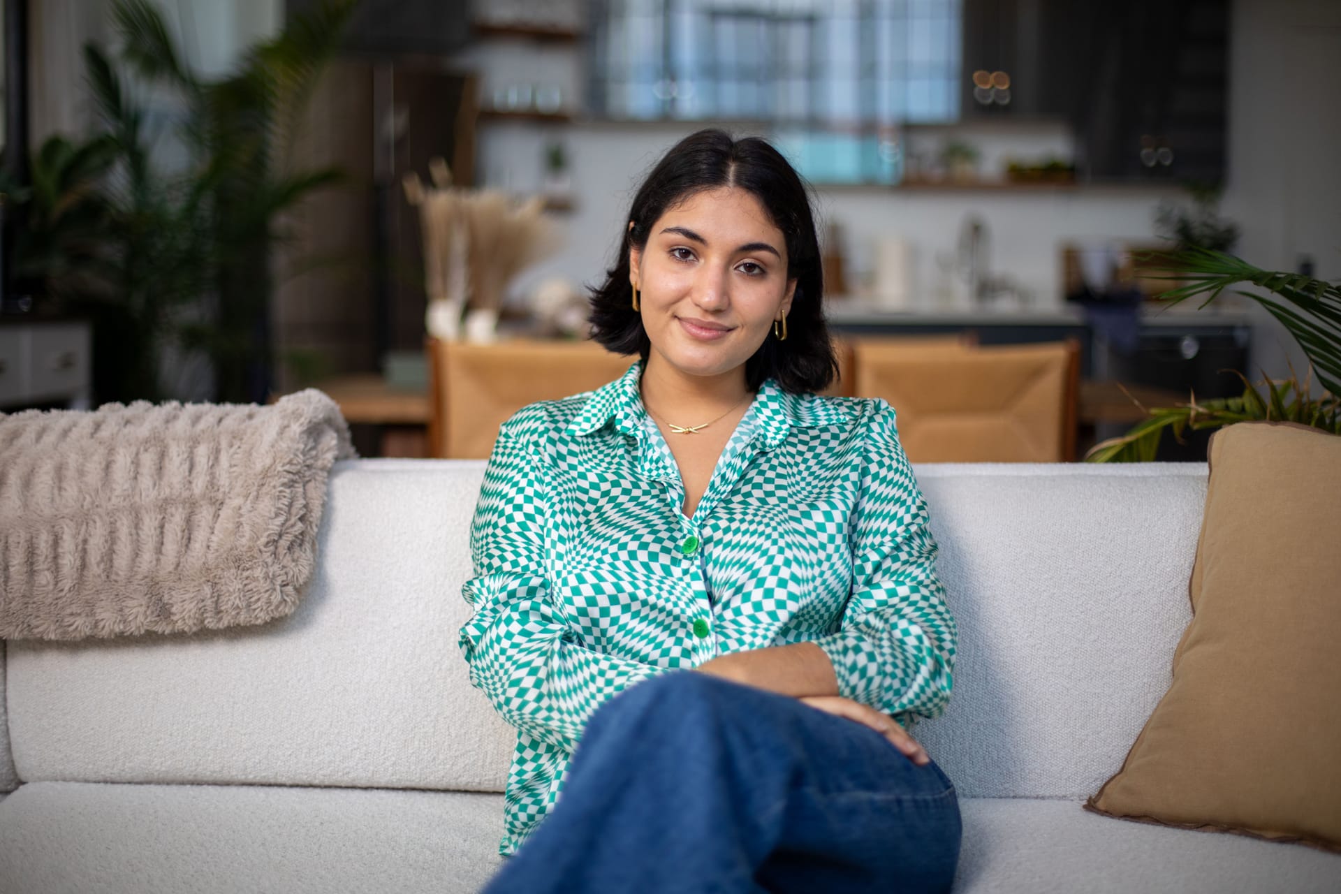 Host of the explainer series Kiana sitting on a couch