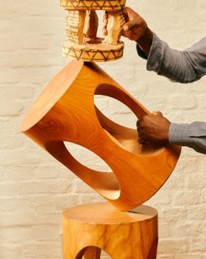 wooden sustainable stool being held by man