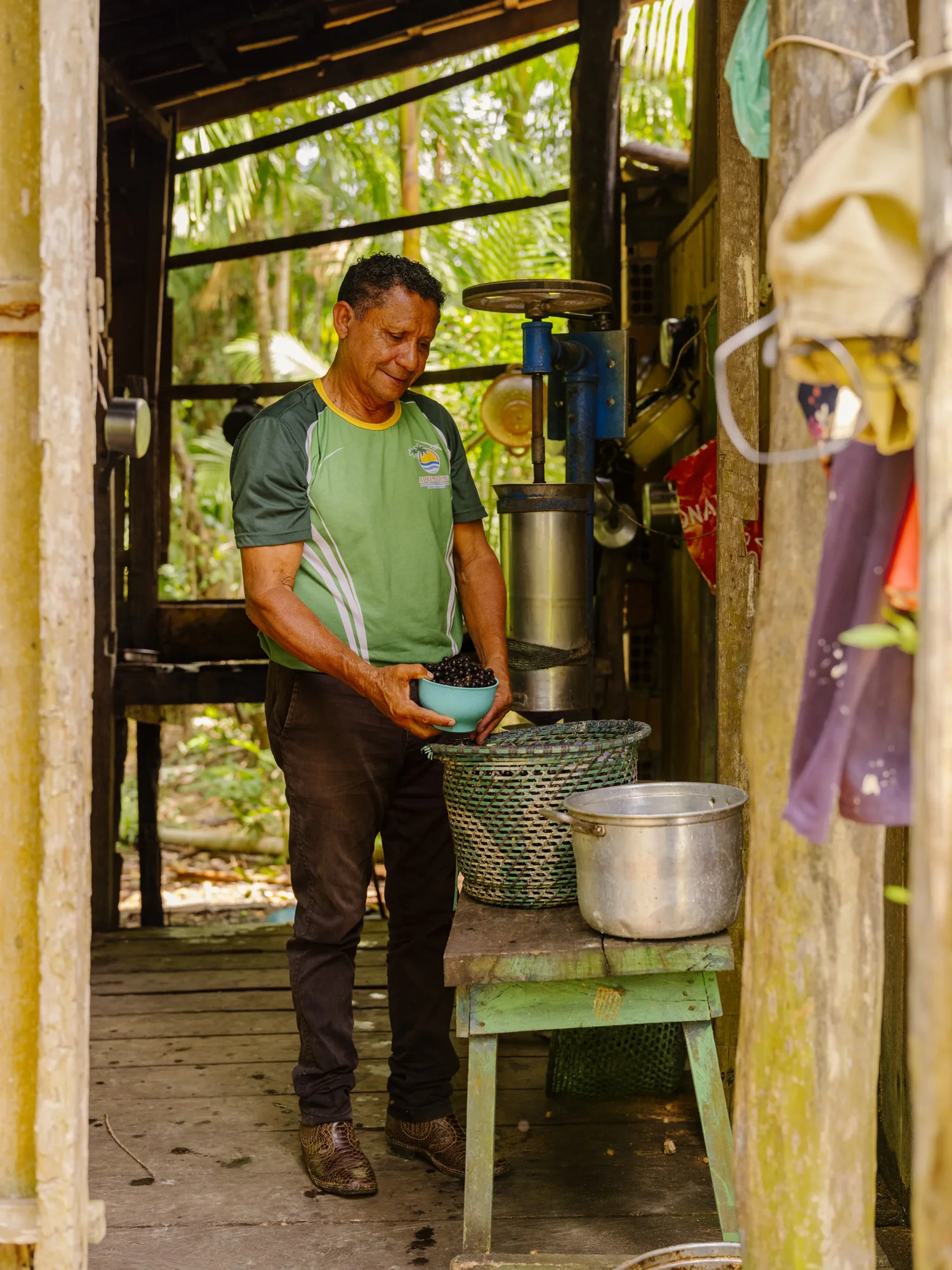 Community leader José Maria de Carvalho Souza at his house, preparing Açaí