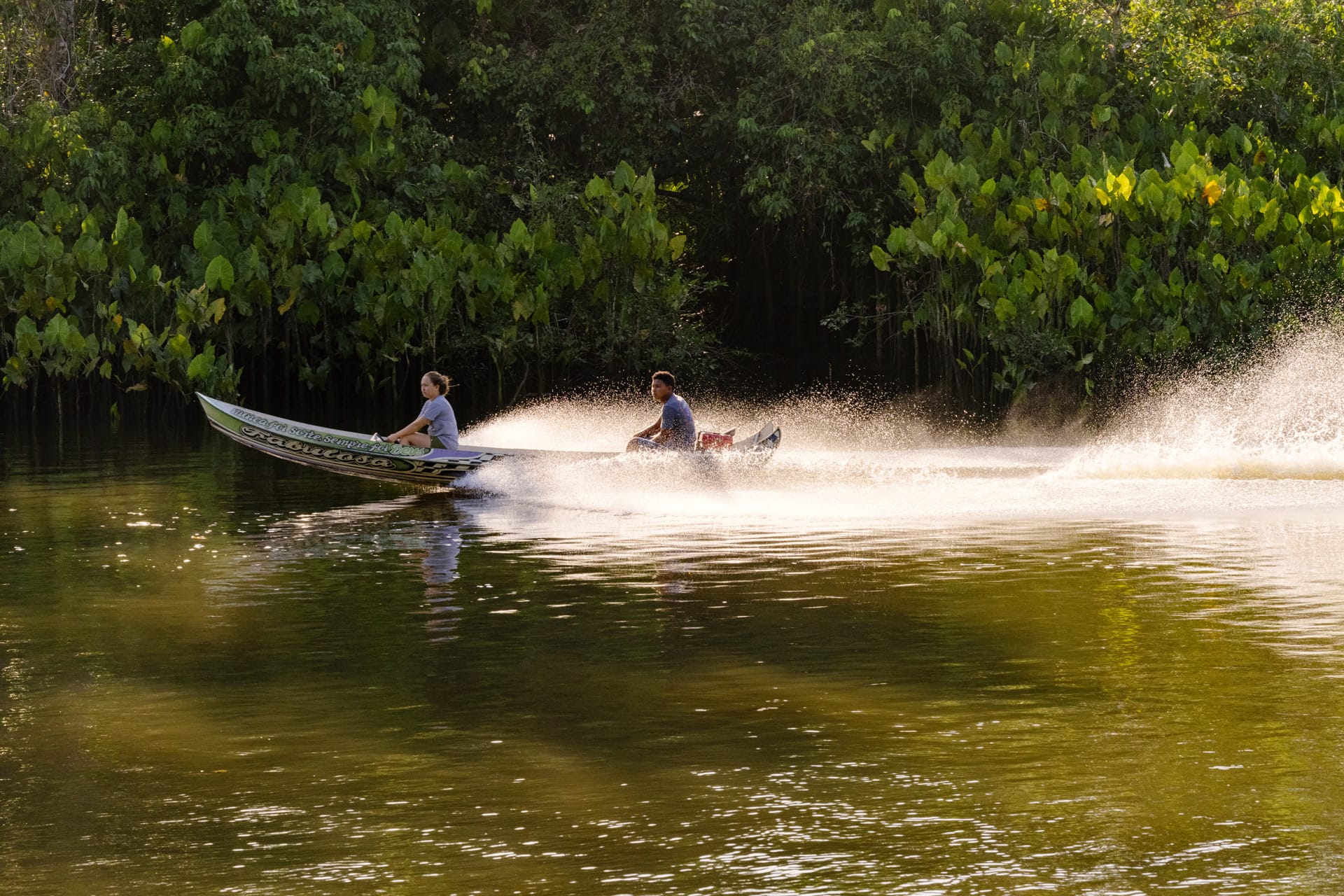 Boat speeding up the river