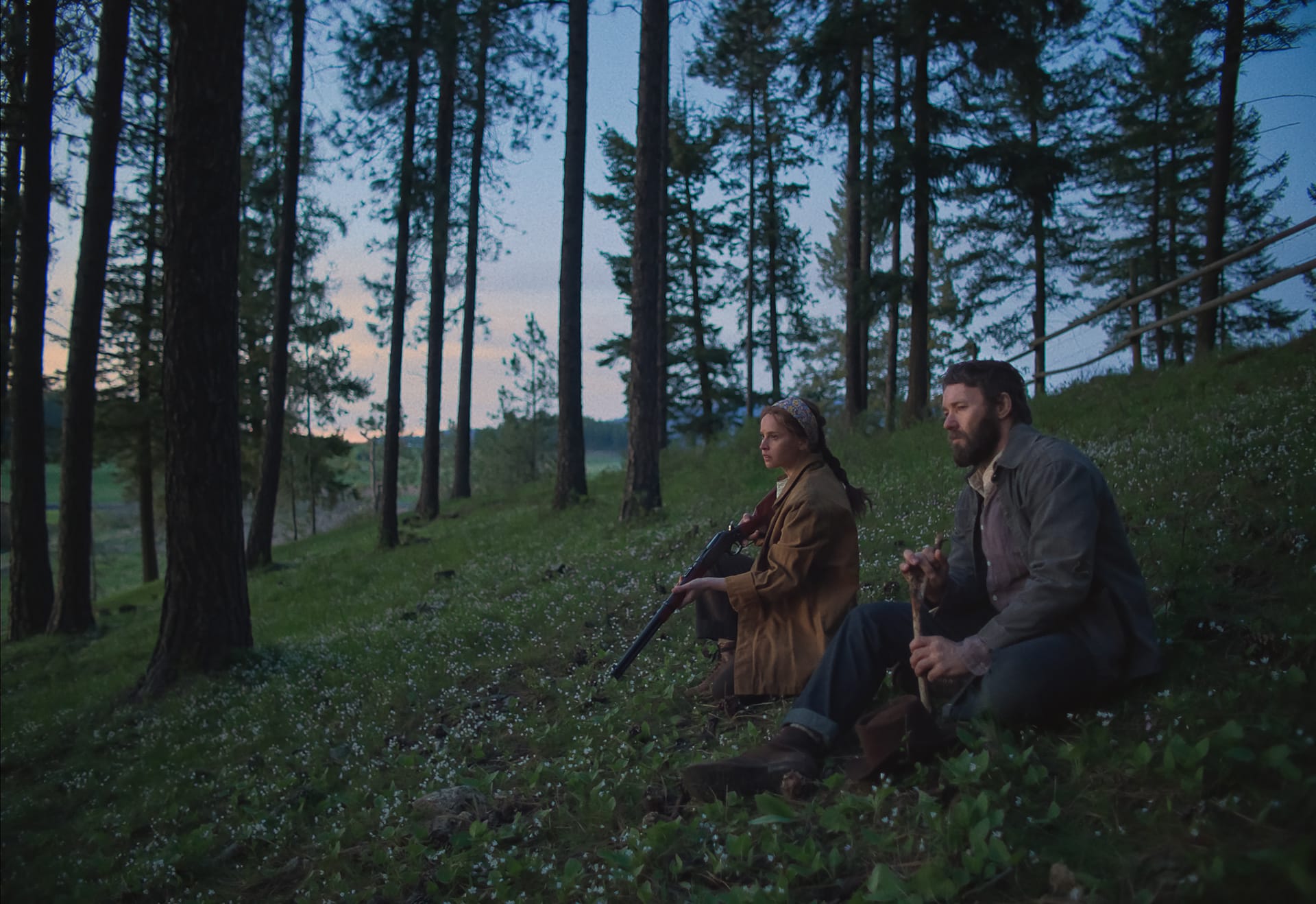 Joel Edgerton as Robert Grainier and Felicity Jones as his wife, Gladys in Train Dreams.